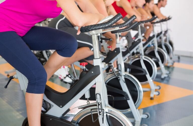 Cyclists pedaling in an indoor cycling class