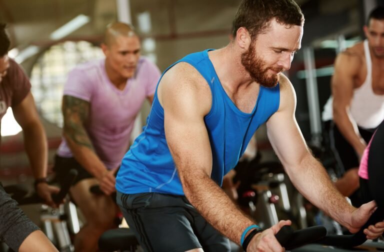 Group taking an indoor cycling class