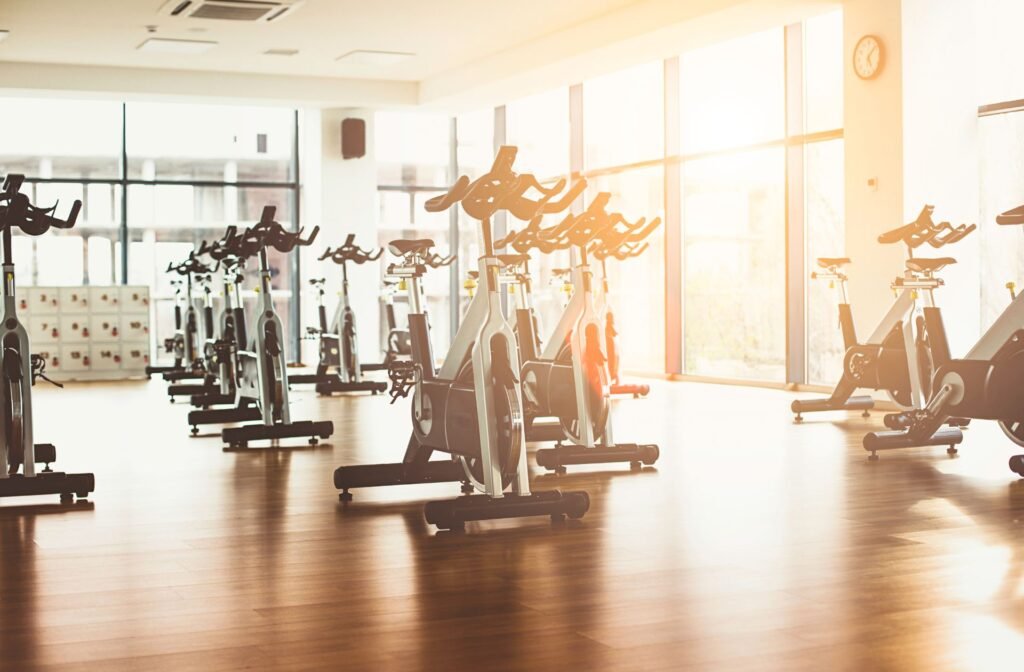 Bright indoor cycling studio with stationary bikes